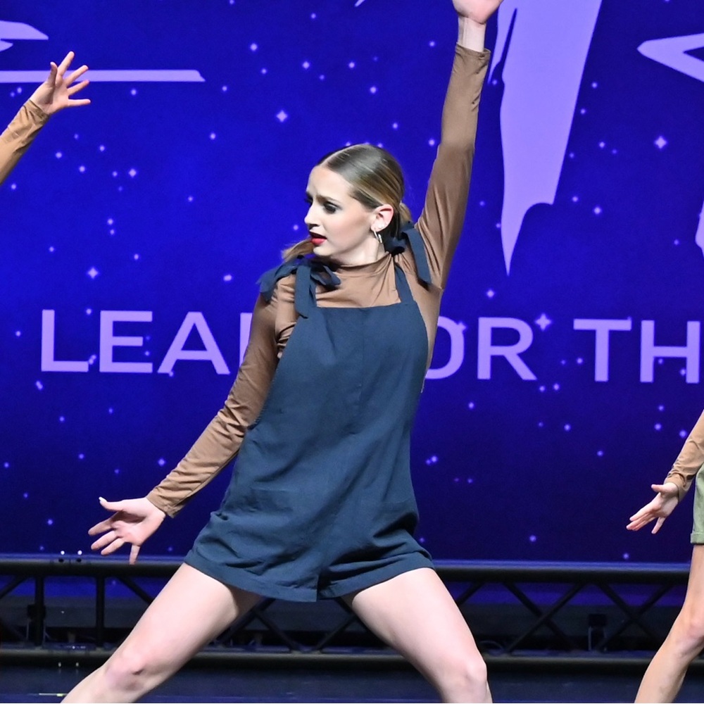 Navy blue linen jumpsuit with brown long sleeve crop top and dance shorts